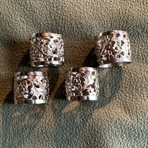 Beautiful set of 4 silver colored napkin rings. Approximately 1 1/2” x 1 1/2”